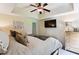 A bright bedroom is accented with a ceiling fan and a large wall-mounted television at 5394 Clairmont Ln, North Charleston, SC 29420