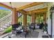Spacious covered patio with comfortable seating, a ceiling fan, and access to a staircase at 5394 Clairmont Ln, North Charleston, SC 29420