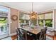 Cozy dining room with natural light, a chandelier, and a door leading to the outdoor area at 5394 Clairmont Ln, North Charleston, SC 29420