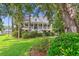 A charming home with a covered porch surrounded by lush greenery at 5394 Clairmont Ln, North Charleston, SC 29420