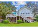 Exterior view of a charming two-story home with a deck and well-maintained lawn at 5394 Clairmont Ln, North Charleston, SC 29420