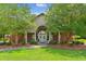 Welcoming front entrance with beautiful landscaping and charming architectural details at 5394 Clairmont Ln, North Charleston, SC 29420