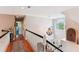 Light-filled hallway features hardwood floors, white railings, and a decorative chandelier at 5394 Clairmont Ln, North Charleston, SC 29420
