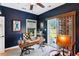 Comfortable home office featuring a wood desk, decor, and view of the backyard through the sliding glass door at 5394 Clairmont Ln, North Charleston, SC 29420