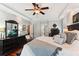 Spacious main bedroom with tray ceiling, ceiling fan, and hardwood floors at 5394 Clairmont Ln, North Charleston, SC 29420