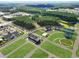Aerial view of a new community with well-designed homes, green spaces, and serene pond at 540 Scholar Way, Summerville, SC 29486