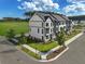Beautiful townhome showing the manicured lawns and modern architectural details, all under a bright blue sky at 540 Scholar Way, Summerville, SC 29486