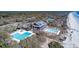 Stunning aerial of beachfront property with pools, a clubhouse, and lush vegetation at 5558 Green Dolphin Way, Kiawah Island, SC 29455