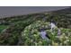 Beautiful aerial view showcasing waterfront homes surrounded by lush trees and a serene lake at 5558 Green Dolphin Way, Kiawah Island, SC 29455
