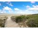 Scenic beach access with a wooden walkway leading to a beautiful sandy shore at 5558 Green Dolphin Way, Kiawah Island, SC 29455