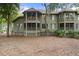 Stylish multi-level condo complex with screened porches and surrounded by lush greenery and trees at 5558 Green Dolphin Way, Kiawah Island, SC 29455
