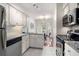 Well-lit kitchen featuring white cabinets, granite countertops, and stainless steel appliances at 5558 Green Dolphin Way, Kiawah Island, SC 29455
