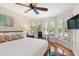 Bright main bedroom features hardwood floors, a queen-size bed, and large windows for natural light at 5558 Green Dolphin Way, Kiawah Island, SC 29455