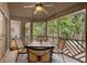 Charming screened-in porch with comfortable seating to enjoy lush, serene wooded views at 5558 Green Dolphin Way, Kiawah Island, SC 29455