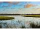 Stunning water view showcasing serene marshland landscape under a partly cloudy blue sky at 5558 Green Dolphin Way, Kiawah Island, SC 29455