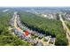Aerial view of a residential area with a mix of homes, trees, and nearby highway at 578 Delafield Dr, Summerville, SC 29483