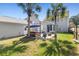 Hot tub and fire pit patio in a beautifully landscaped backyard with tall palms at 578 Delafield Dr, Summerville, SC 29483
