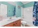 Bright bathroom with a single sink vanity, toilet, and combination tub and shower with tiled walls at 578 Delafield Dr, Summerville, SC 29483