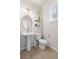 Well-lit bathroom features a pedestal sink, tiled floor, and modern fixtures at 578 Delafield Dr, Summerville, SC 29483