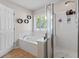 Bright bathroom featuring a soaking tub, stand up shower and neutral color palette at 578 Delafield Dr, Summerville, SC 29483