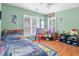 Bright bedroom features a window with wooden shutters, a ceiling fan, and colorful decor at 578 Delafield Dr, Summerville, SC 29483
