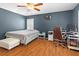 A primary bedroom featuring a ceiling fan, window with shutters, and a dedicated workspace at 578 Delafield Dr, Summerville, SC 29483