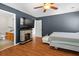 A primary bedroom featuring a ceiling fan, and decorative fireplace, with a view of the ensuite bathroom at 578 Delafield Dr, Summerville, SC 29483