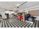 Spacious garage featuring a black and white checkered floor and ample storage space at 578 Delafield Dr, Summerville, SC 29483