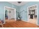 Bright hallway with hardwood floors with a view into a den and kitchen at 578 Delafield Dr, Summerville, SC 29483