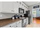 Charming kitchen features granite countertops, stainless steel appliances, white cabinets, and a tile floor at 578 Delafield Dr, Summerville, SC 29483