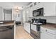 Eat-in kitchen featuring stainless steel appliances, granite countertops, white cabinets, and a tile floor at 578 Delafield Dr, Summerville, SC 29483