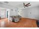 Open living room with hardwood floors, comfortable gray furniture, ceiling fan and a staircase at 578 Delafield Dr, Summerville, SC 29483