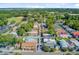 High-angle shot of a quaint neighborhood featuring colorful houses and verdant trees with baseball field in distance at 6 Dewey St, Charleston, SC 29403
