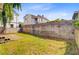 Fenced backyard with grass and concrete pads surrounded by neighboring houses at 6 Dewey St, Charleston, SC 29403