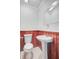 The bathroom features a pedestal sink, wood paneling and white tile flooring at 6 Dewey St, Charleston, SC 29403