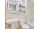 Bathroom features a pedestal sink, toilet, metal shelves, and a shower/tub combo at 6 Dewey St, Charleston, SC 29403