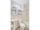 Bathroom features a pedestal sink, toilet, metal shelves, and a shower/tub combo at 6 Dewey St, Charleston, SC 29403