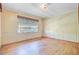 Bedroom with hardwood floors, a large window with blinds, and white wainscoting on the walls at 6 Dewey St, Charleston, SC 29403