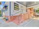 Angle view showcasing brick steps, covered area, and side yard of a charming single-story home at 6 Dewey St, Charleston, SC 29403
