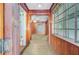 Hallway with wood paneling and tile floors leading to a large room with ample natural light at 6 Dewey St, Charleston, SC 29403