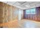 Living room with wood paneled walls, hardwood flooring, and natural light at 6 Dewey St, Charleston, SC 29403
