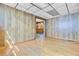 Living room with wood paneling and hardwood flooring, with view into another room at 6 Dewey St, Charleston, SC 29403