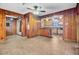 Open living room featuring wood paneling, tile flooring and views of the kitchen at 6 Dewey St, Charleston, SC 29403