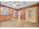 Spacious living room featuring wood paneling and views of the kitchen area at 6 Dewey St, Charleston, SC 29403