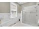 Bright bathroom featuring a glass shower, white fixtures, and classic hexagonal tile flooring at 68 Vanderhorst St # A, Charleston, SC 29403