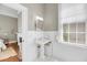 Cozy bathroom featuring a pedestal sink, hexagonal tile floor, and natural light from a window at 68 Vanderhorst St # A, Charleston, SC 29403