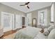 Bright bedroom with wood floors, spiral staircase view, and attached bathroom at 68 Vanderhorst St # A, Charleston, SC 29403