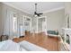 Spacious bedroom with wood floors, fireplace and bench, ample windows, and neutral decor at 68 Vanderhorst St # A, Charleston, SC 29403