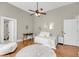 Bright bedroom features wood floors, ceiling fan, and natural light with attached bathroom at 68 Vanderhorst St # A, Charleston, SC 29403