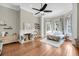 Bright bedroom boasts wood floors, fireplace, ceiling fan and abundant natural light from large bay windows at 68 Vanderhorst St # A, Charleston, SC 29403